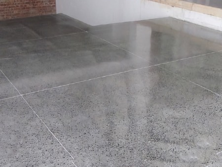 Grind down the concrete to the desired level of exposure and apply a surface protective coating.